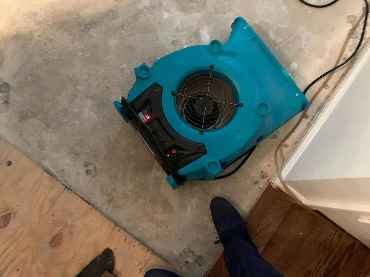 Air mover drying subfloor during Commercial Water Damage Restoration in Spring Valley Lake